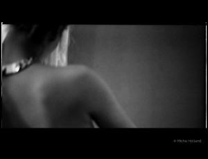 Naked shoulder by Micha Holland. The black-and-white photo shows Cate Martin’s naked shoulder from a very close angle.